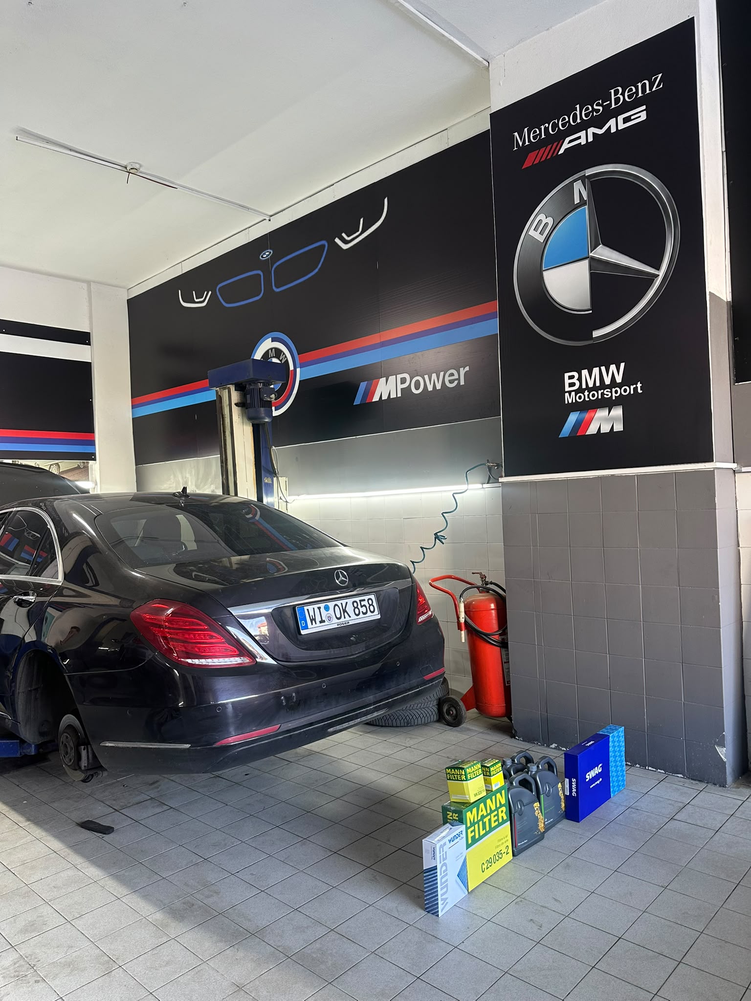 Bakım için lifte alınmış Mercedes-Benz sedan